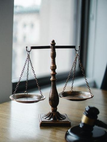 scales of justice next to judge's gavel