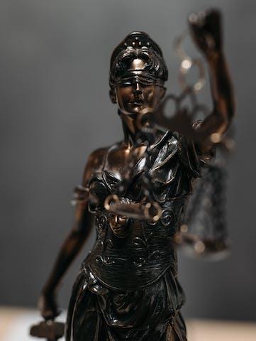 a close up photo a Lady Justice statue