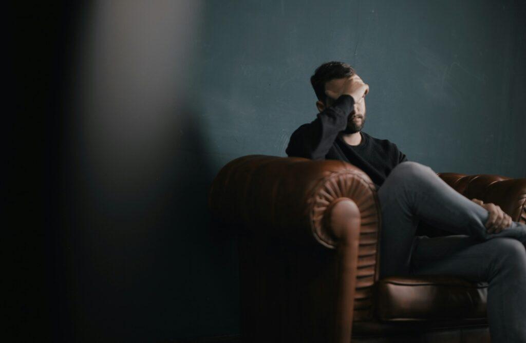 a man covering his face