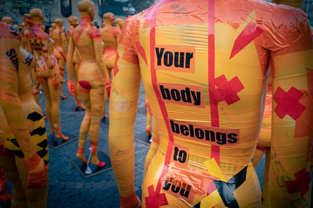 a mannequin with the words "your body belongs to you" printed on it